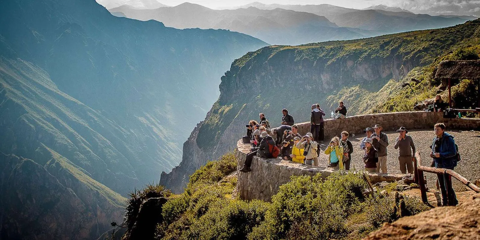 Walkers beside a Colca Canyon stone viewpoint