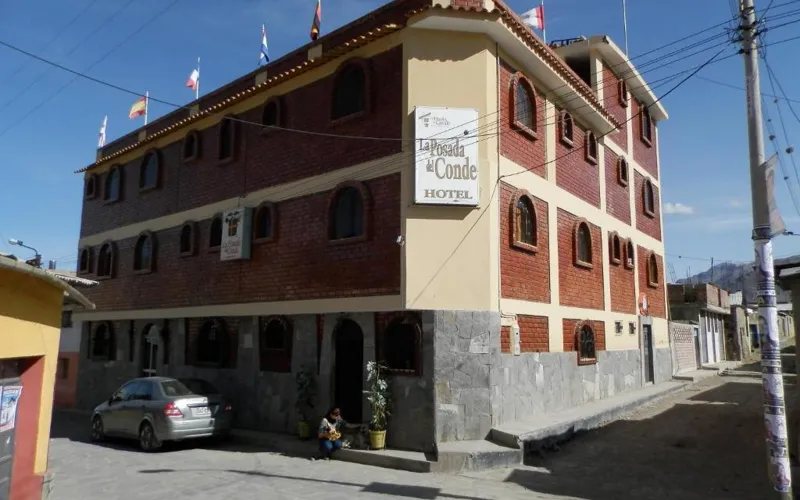a building with a sign on the front of it at La Posada Del Conde in Cabanaconde